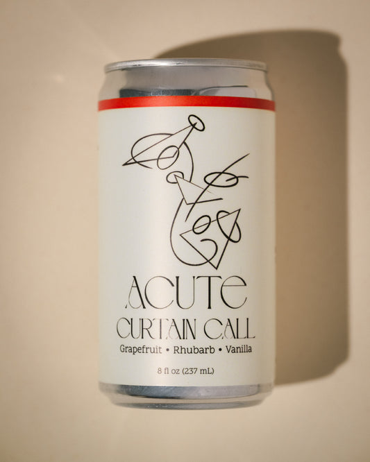 Can of 'Acute Curtain Call' with a decorative label on a beige background